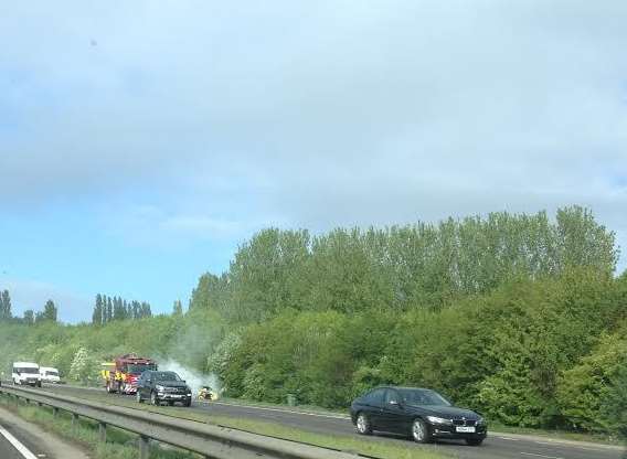 Smoke billowing from the burning car