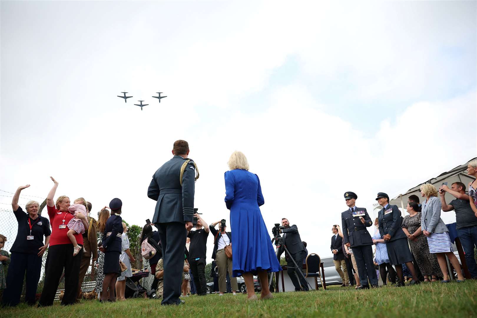 A flypast overhead as Camilla tours the base (Phil Noble/PA)