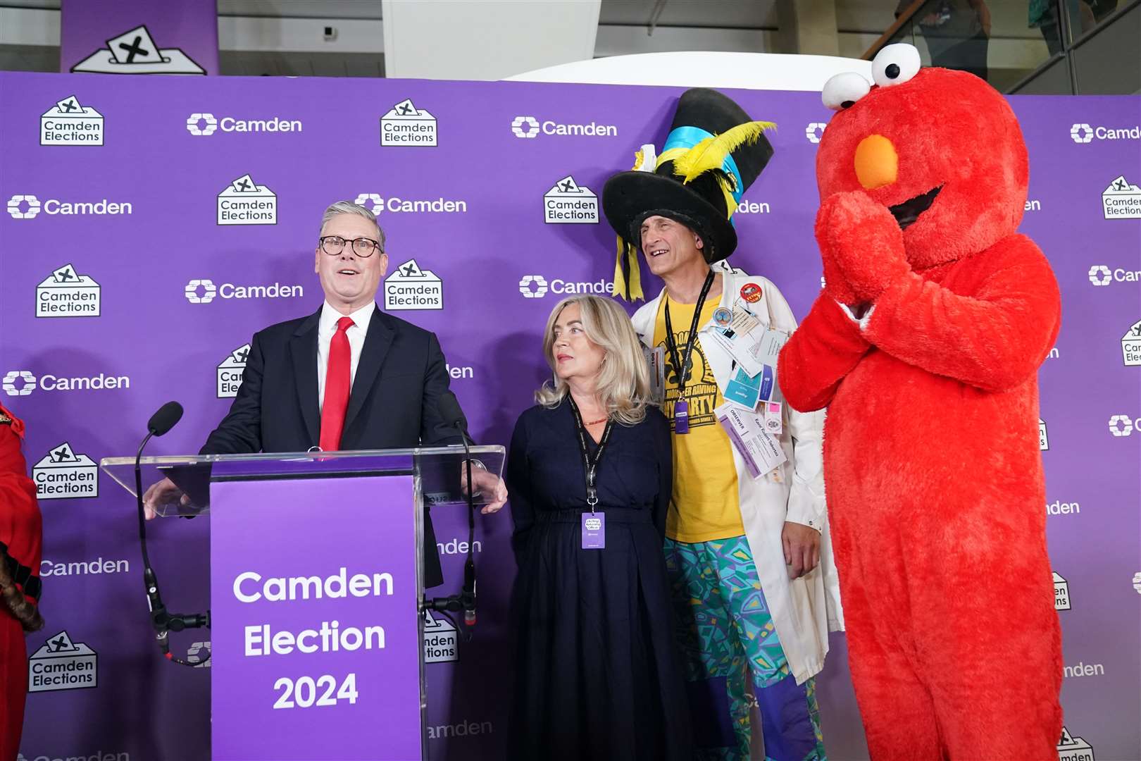 Labour leader Sir Keir Starmer (left) gives a victory speech watched by Nick the Incredible Flying Brick (second right) and Bobby ‘Elmo’ Smith (right) (Stefan Rousseau/PA)