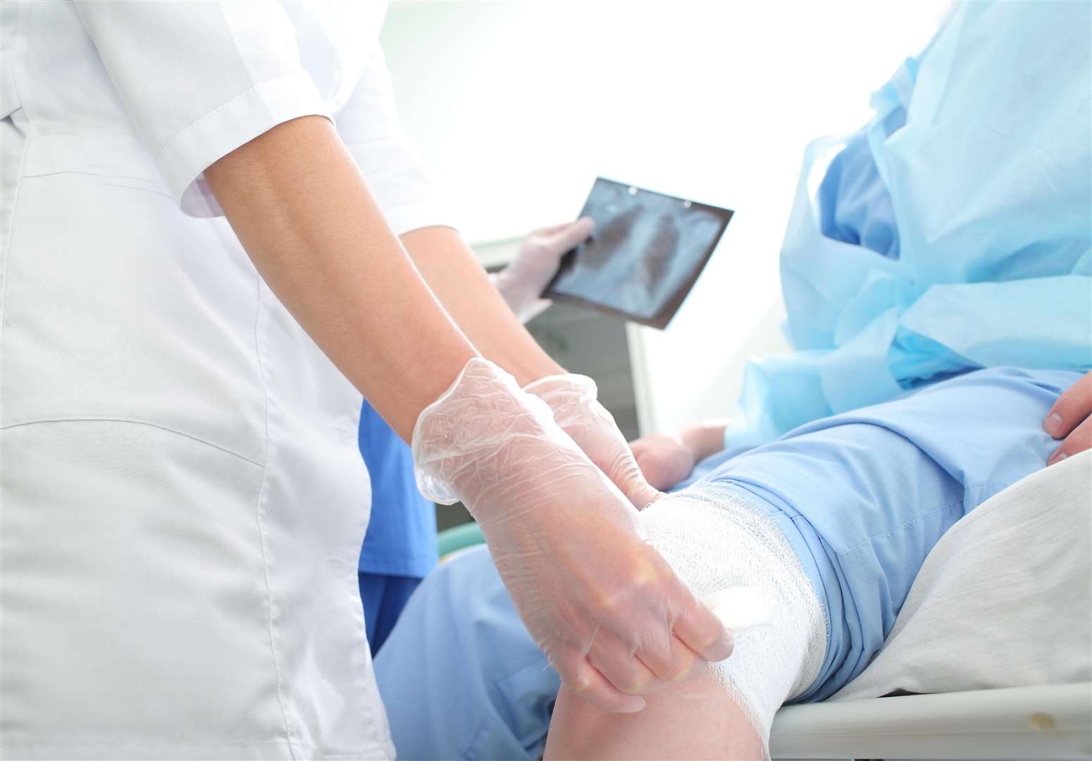 Nurse bandaging a patient in an emergency room