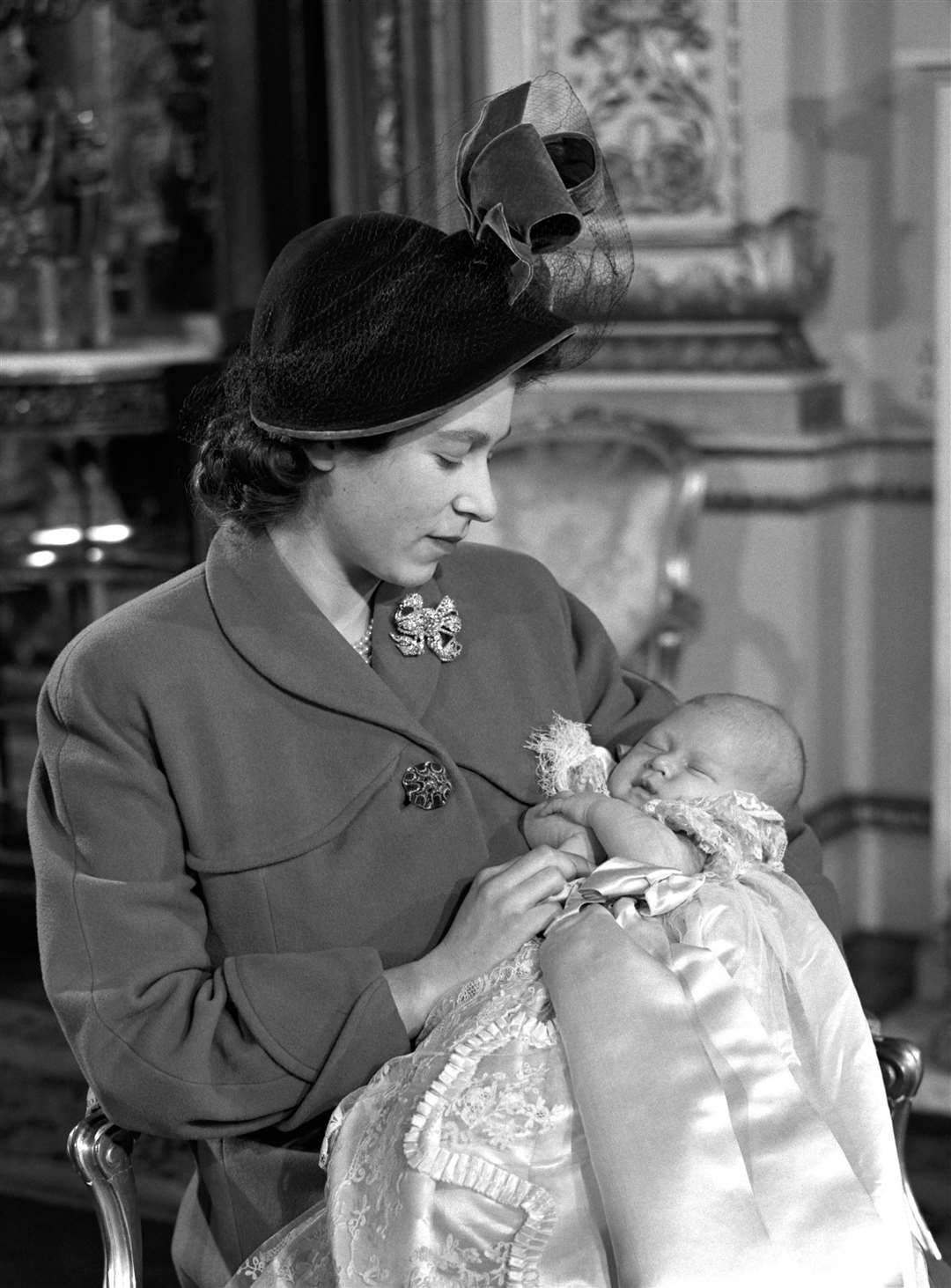 Charles pictured in the arms of his mother, the late Queen, after his christening in 1948 (PA)