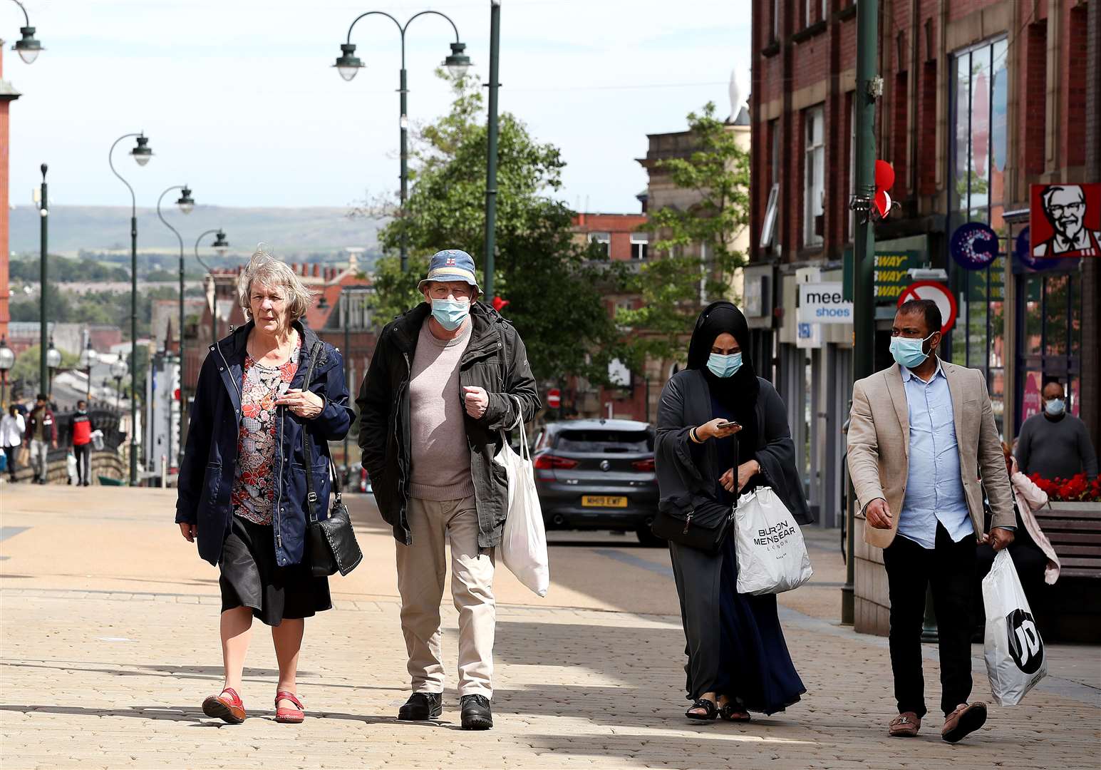 People shopping in Oldham (Martin Rickett/PA)