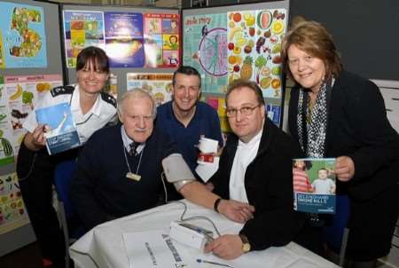 lan Hill - Standford Hill Prison IMB gets a blood pressure check from Simon Jenner - health care officer watched by (left) Amanda Syddell - diversity manager, Gary Lyttle - head of physical education, Sheppey prison cluster and Teressa Clifford - managing learning centre for staff and family.