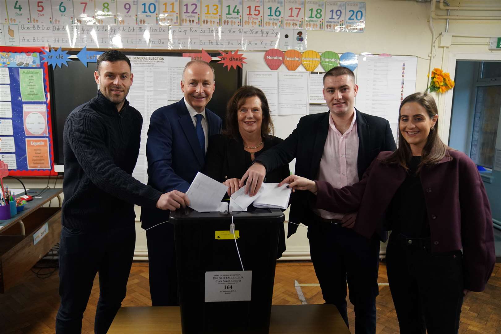 Tanaiste and Fianna Fail leader Micheal Martin, accompanied by his family, casts his vote at St Anthony’s Boys’ School in Cork (Jacob KIng/PA)