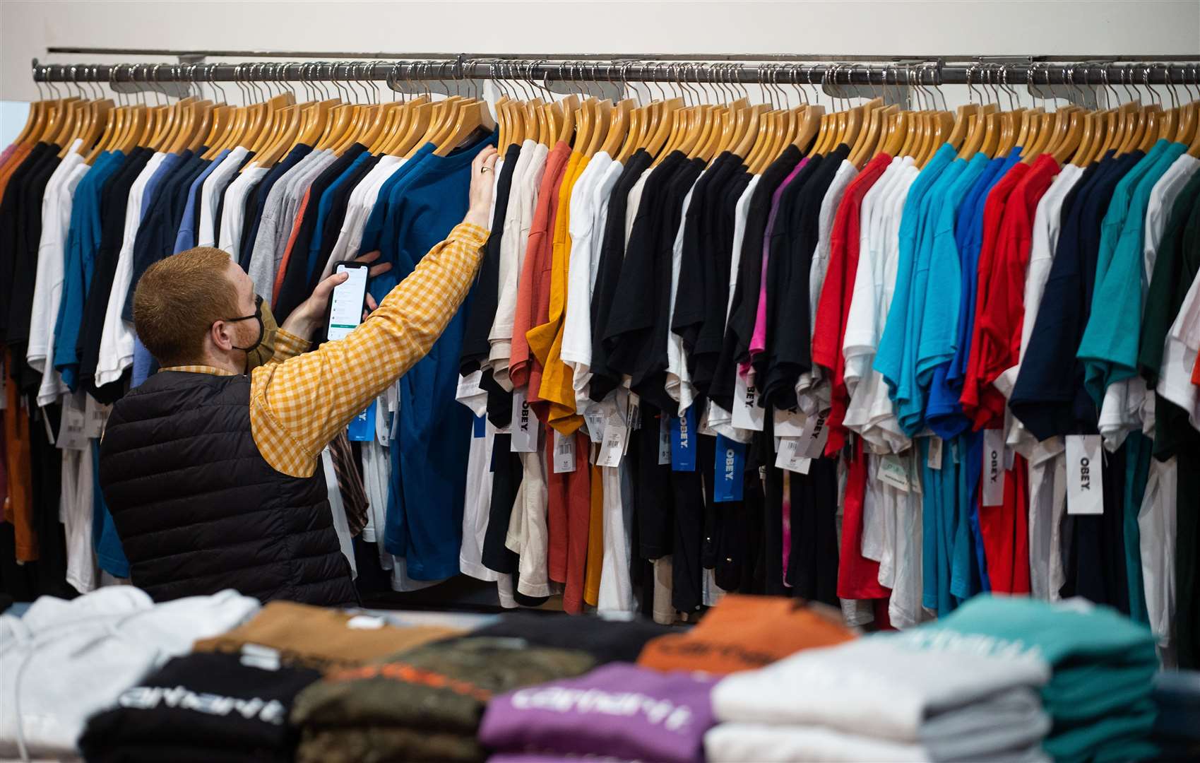 A member of staff checks stock at Dogfish menswear in Norwich (Joe Giddens/PA)