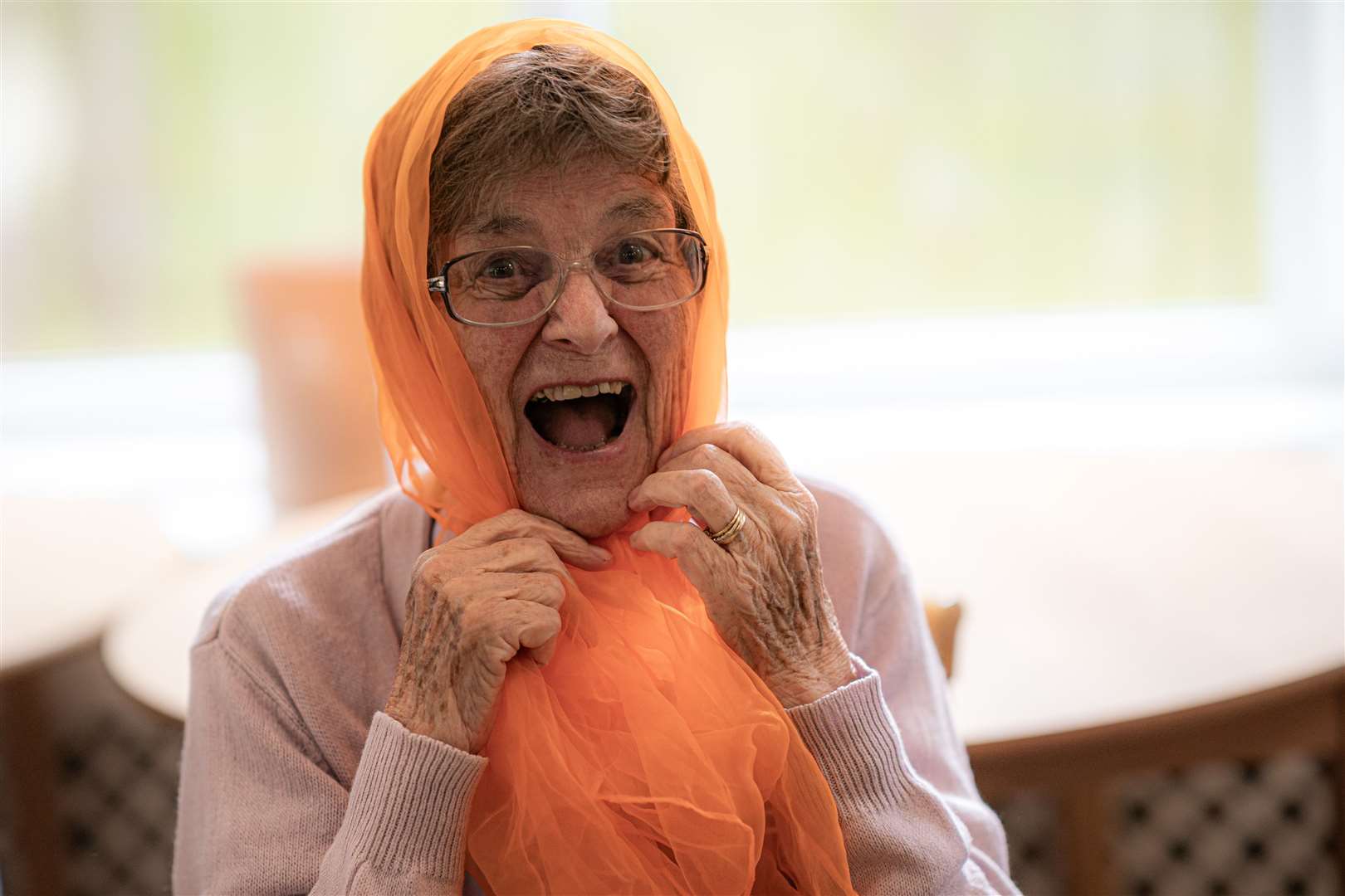 Betty Bealey, 87, plays around with an orange scarf (Ben Birchall/PA)