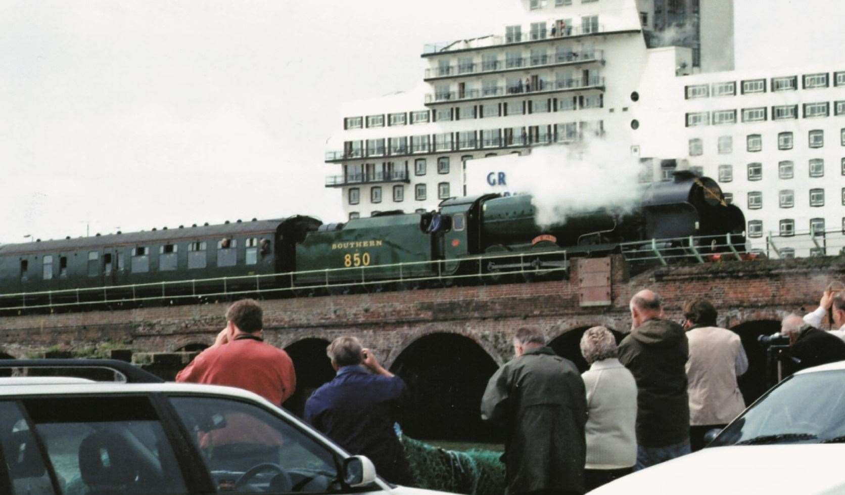 The steam train Lord Nelson on the harbour branch line being operated as the Golden Arrow, August 2007. The Burstin Hotel in the background