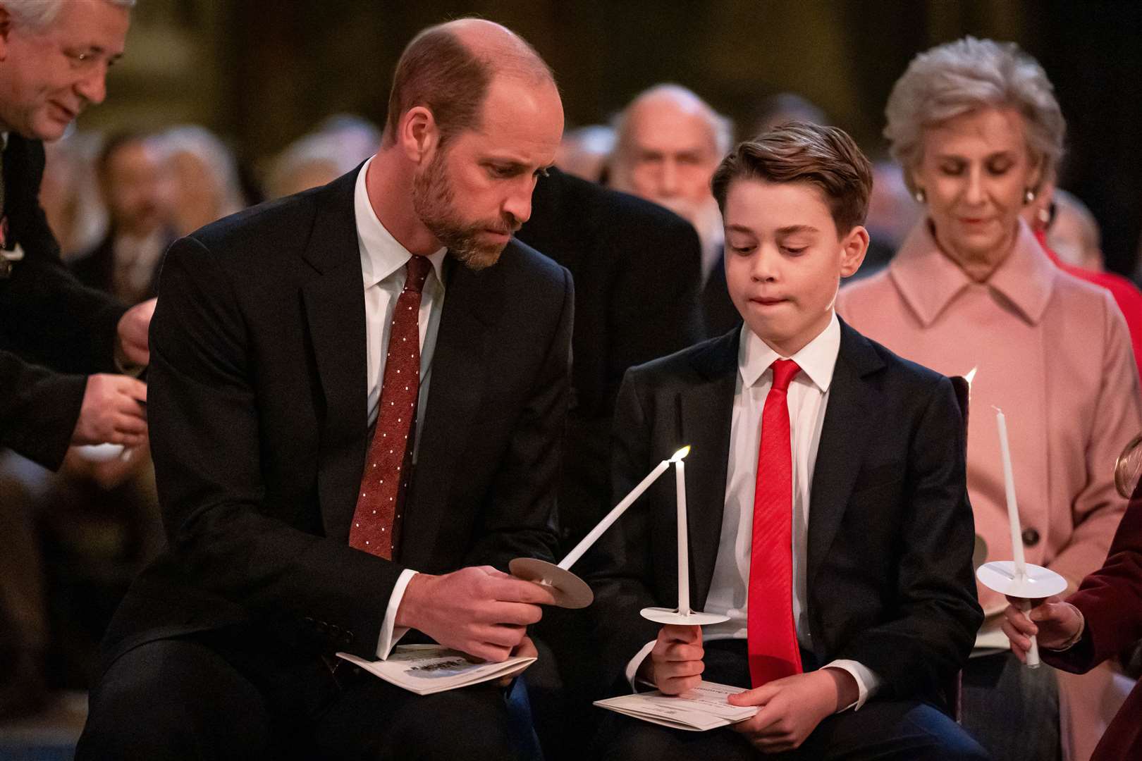 The Prince of Wales and Prince George light candles during the service (Aaron Chown/PA)