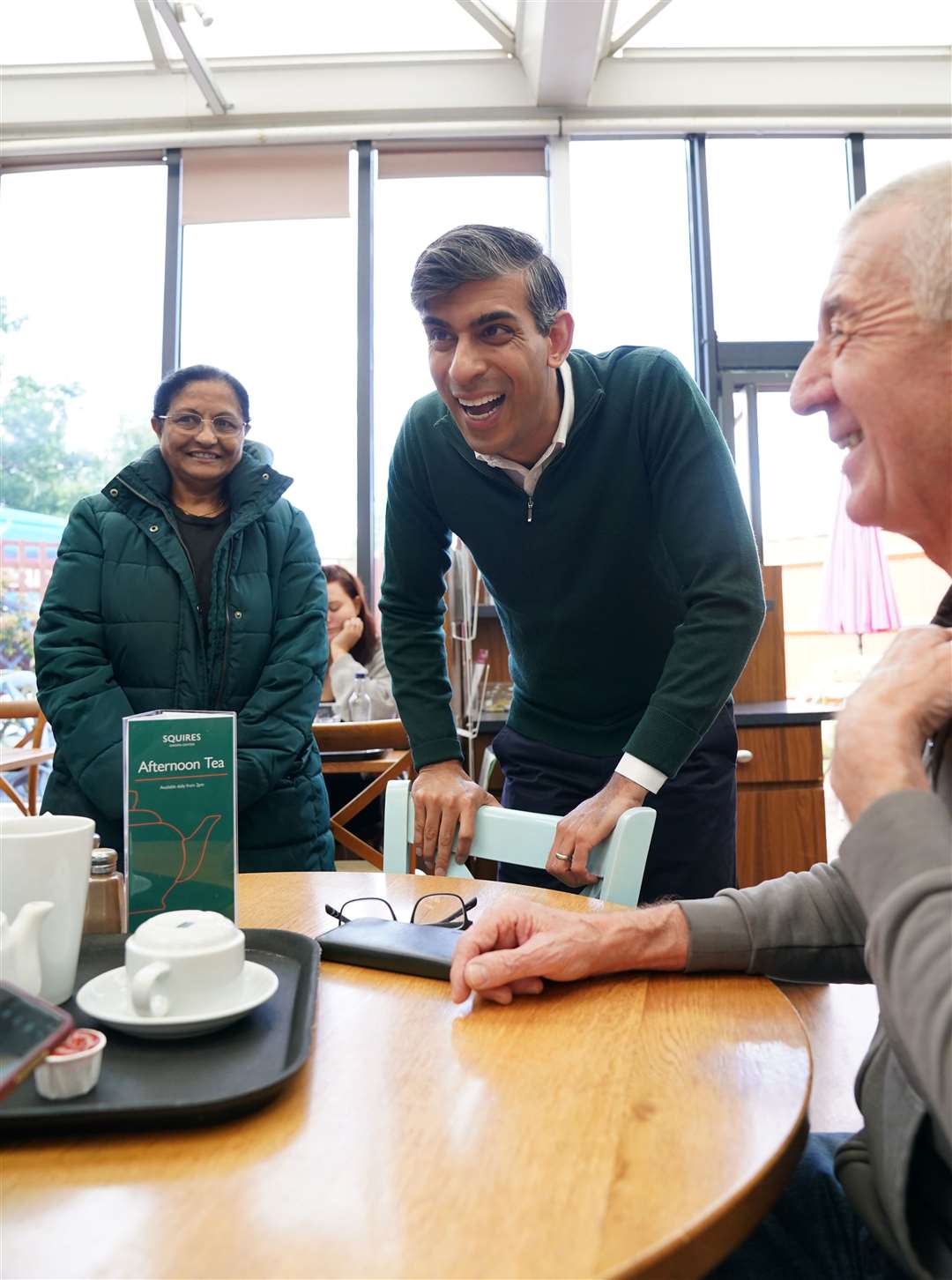 Prime Minister Rishi Sunak talking to locals at a cafe in Squires Garden Centre in Crawley (Gareth Fuller/PA)