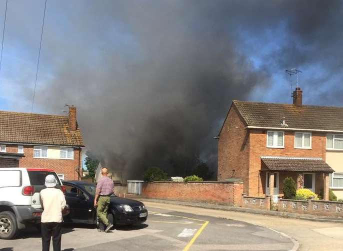 Thick black smoke billowing from the homes