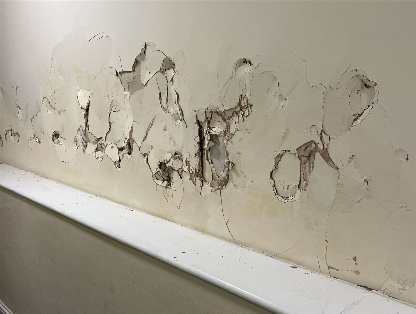 The wall at the entry of the Metropole flats in Dover has been badly damaged by vandals. Picture: Steve Davies