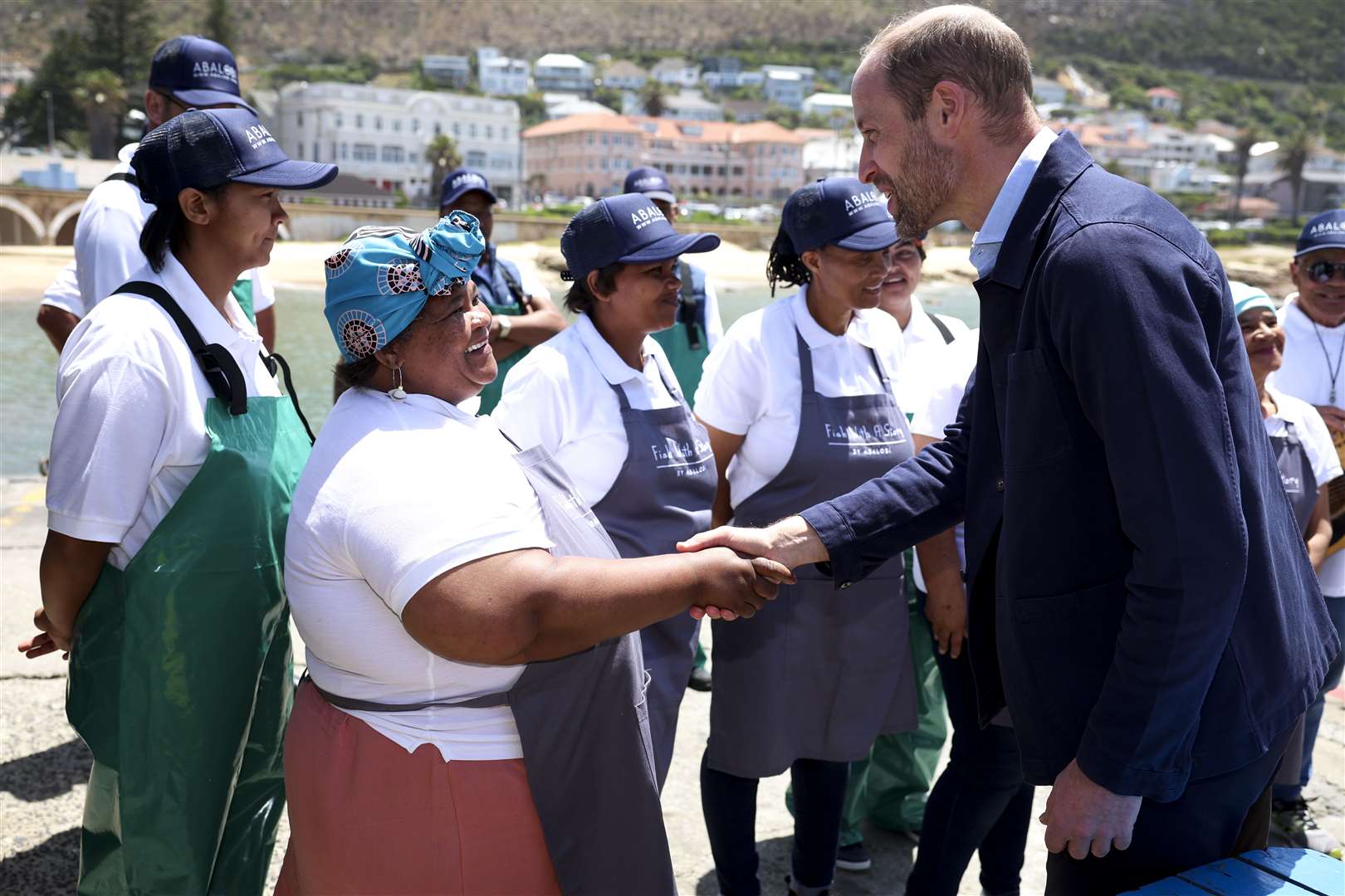 The Prince of Wales meeting local fishermen in Kalk Bay Harbour, Cape Town, to highlight the contributions of 2023 Earthshot finalist Abalobi (Phil Noble/PA)