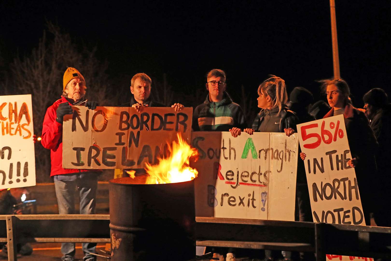 Protesters from Border Communities Against Brexit campaign on the border between Counties Louth in the Irish Republic and Armagh in Northern Ireland (Niall Carson/PA)