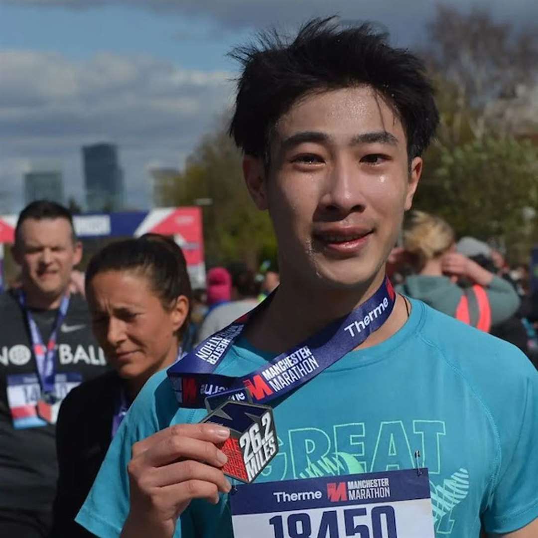 Viet-Anh crying tears of joy after finishing the Manchester Marathon in 2022 (University of Bristol/PA)