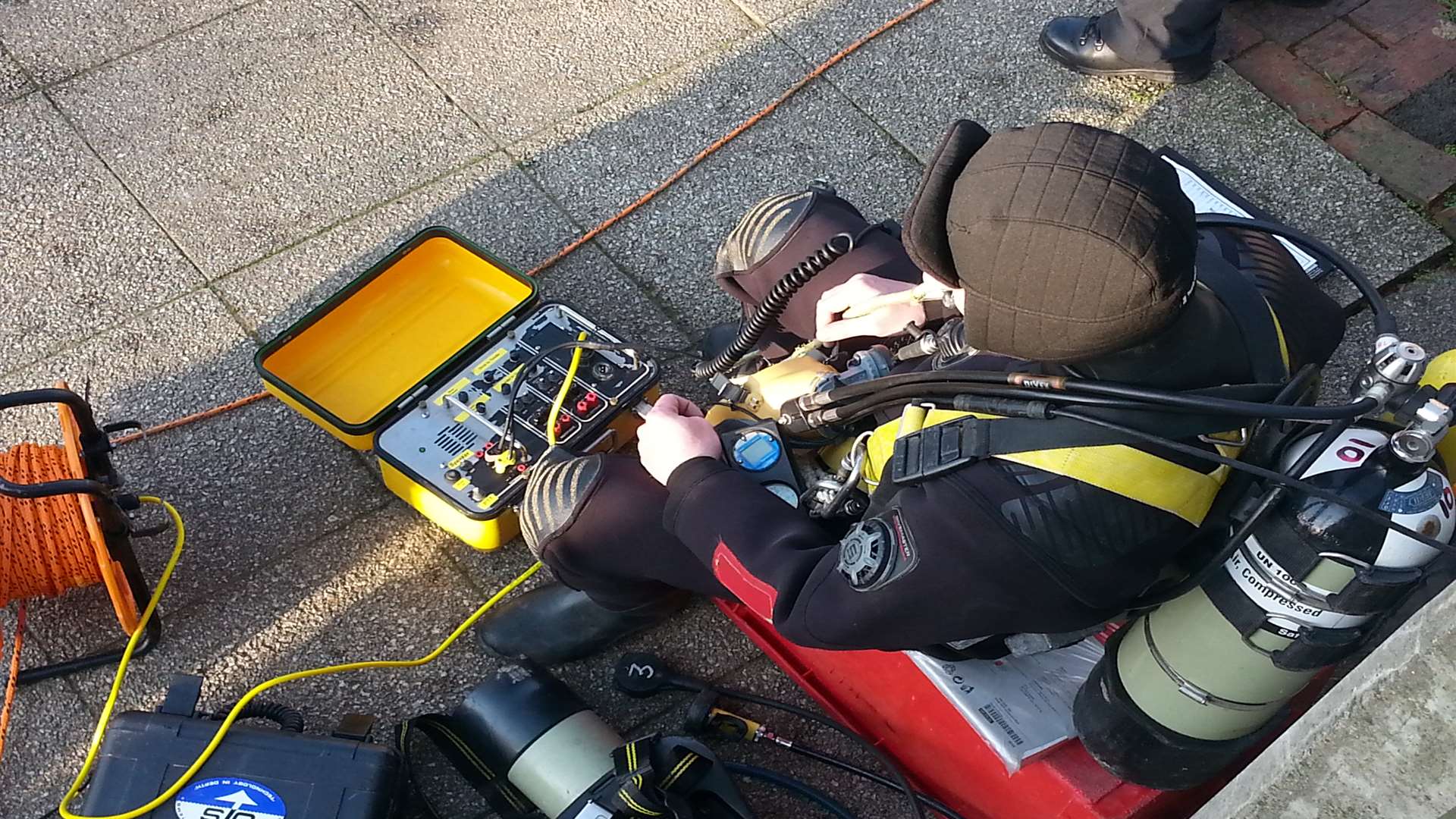 A police diver on the bank of the River Medway