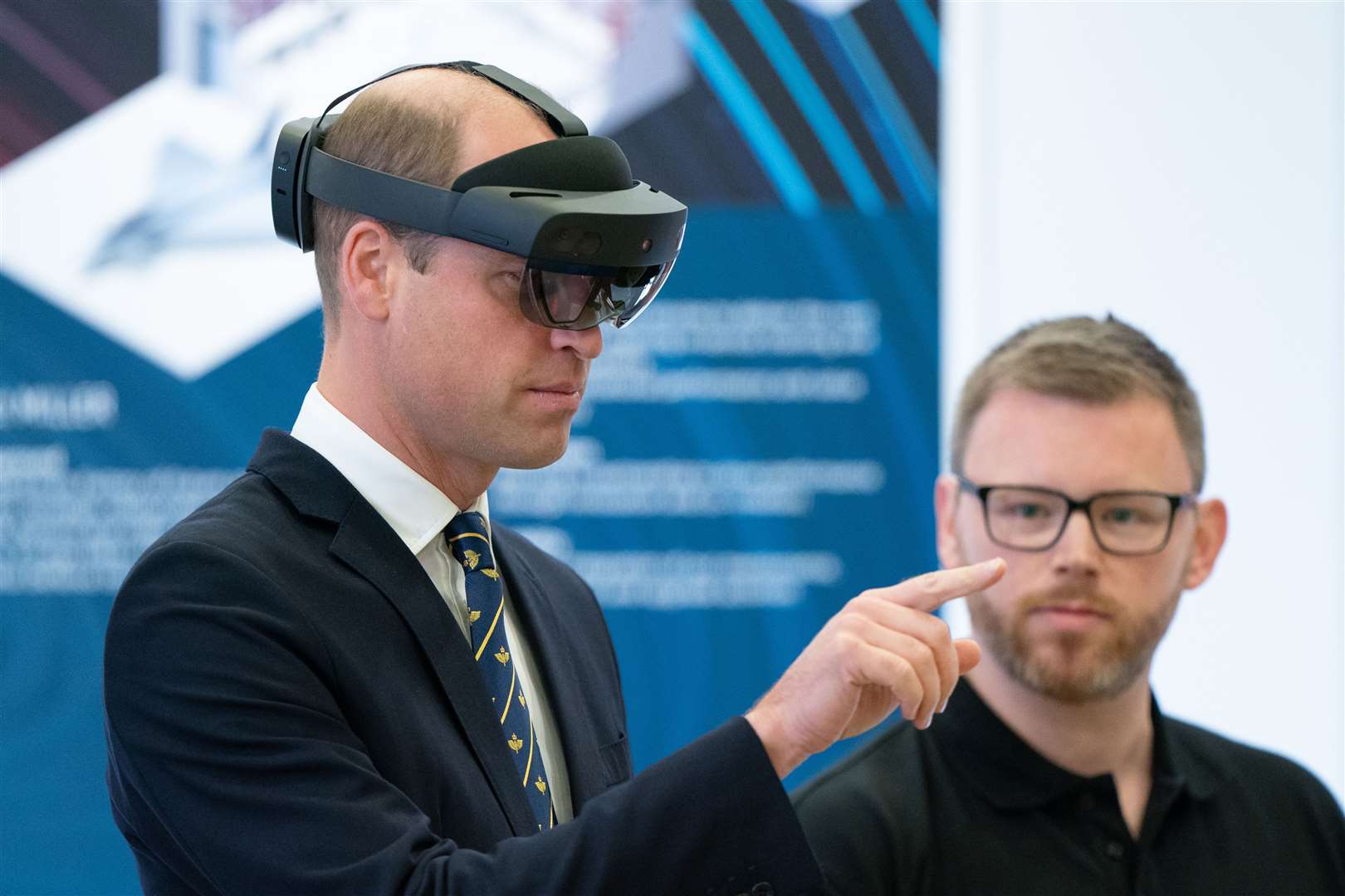 The Prince of Wales wearing a virtual reality headset in the BAE Systems Typhoon Maintenance Facility (Joe Giddens/PA)