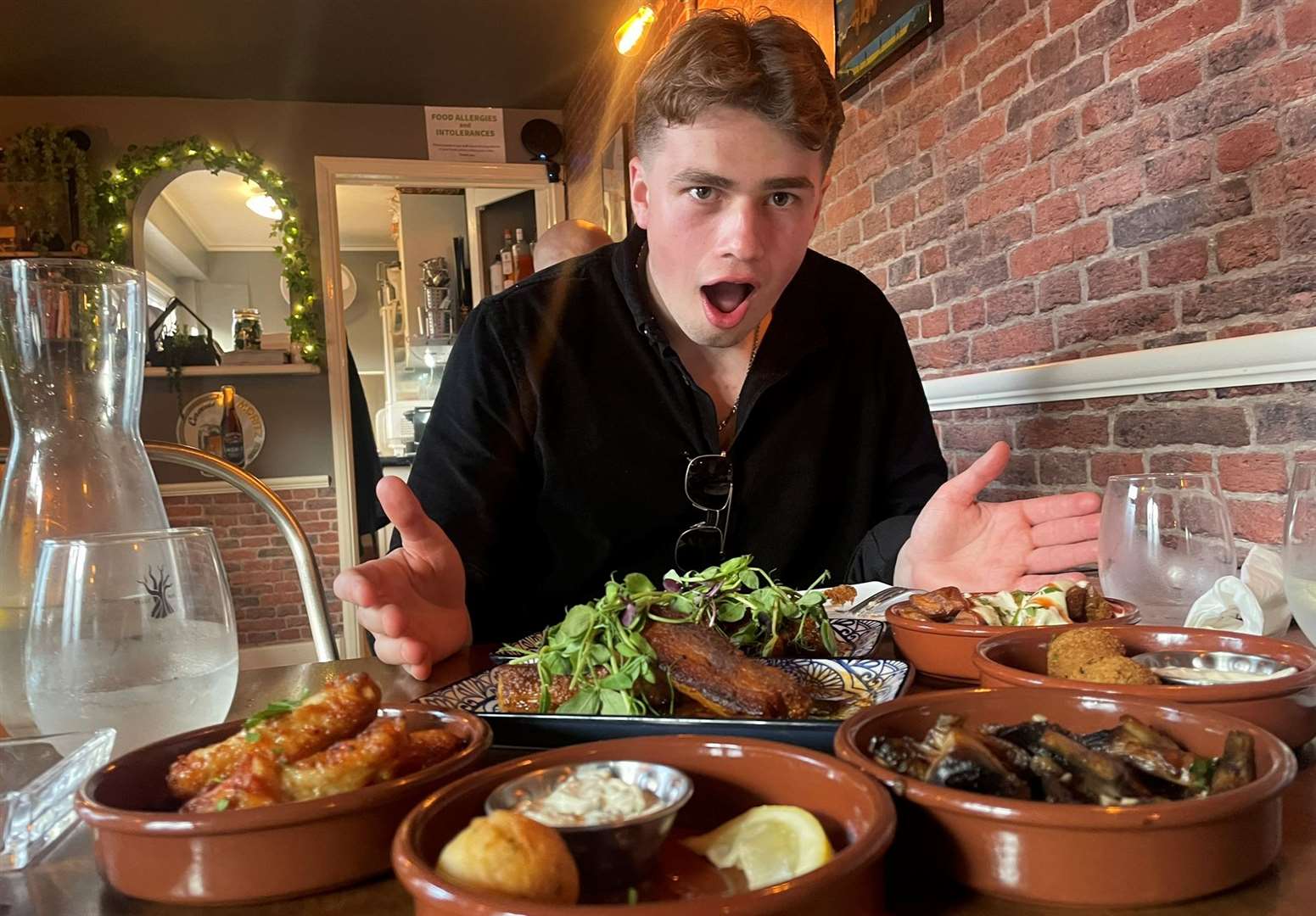 Reporter Joe Crossley surrounded by tapas dishes in West Street Tapas in Queenborough - our highest rated restaurant of 2024