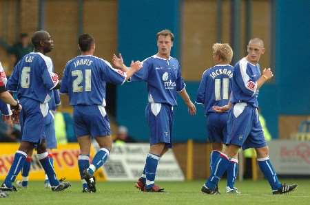 Gillingham's players congratulate Mike Flynn after the midfielder's winning goal. Picture: GRANT FALVEY