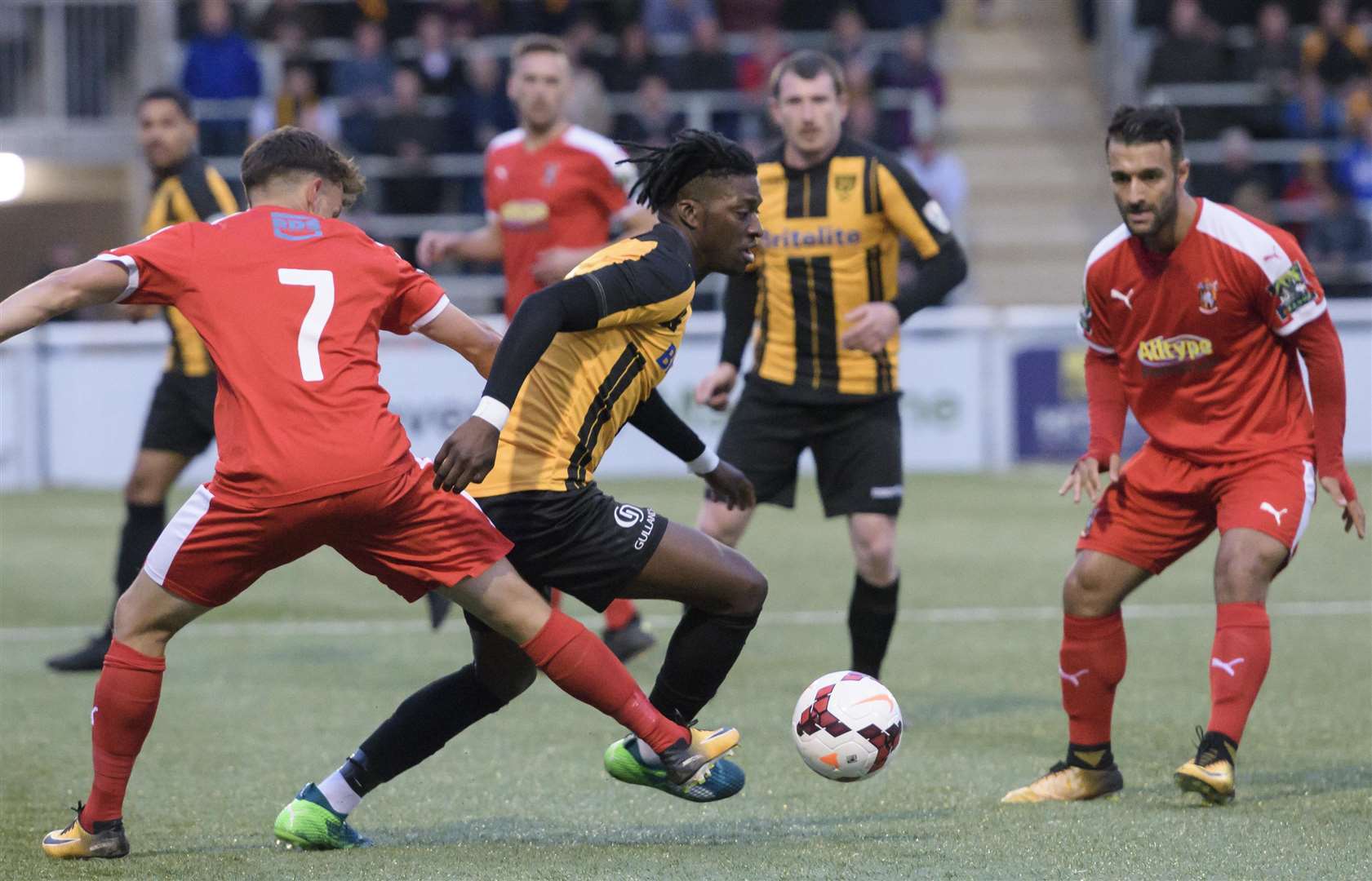 Andre Coker goes around Folkestone's former Maidstone forward Johan Ter Horst Picture: Andy Payton