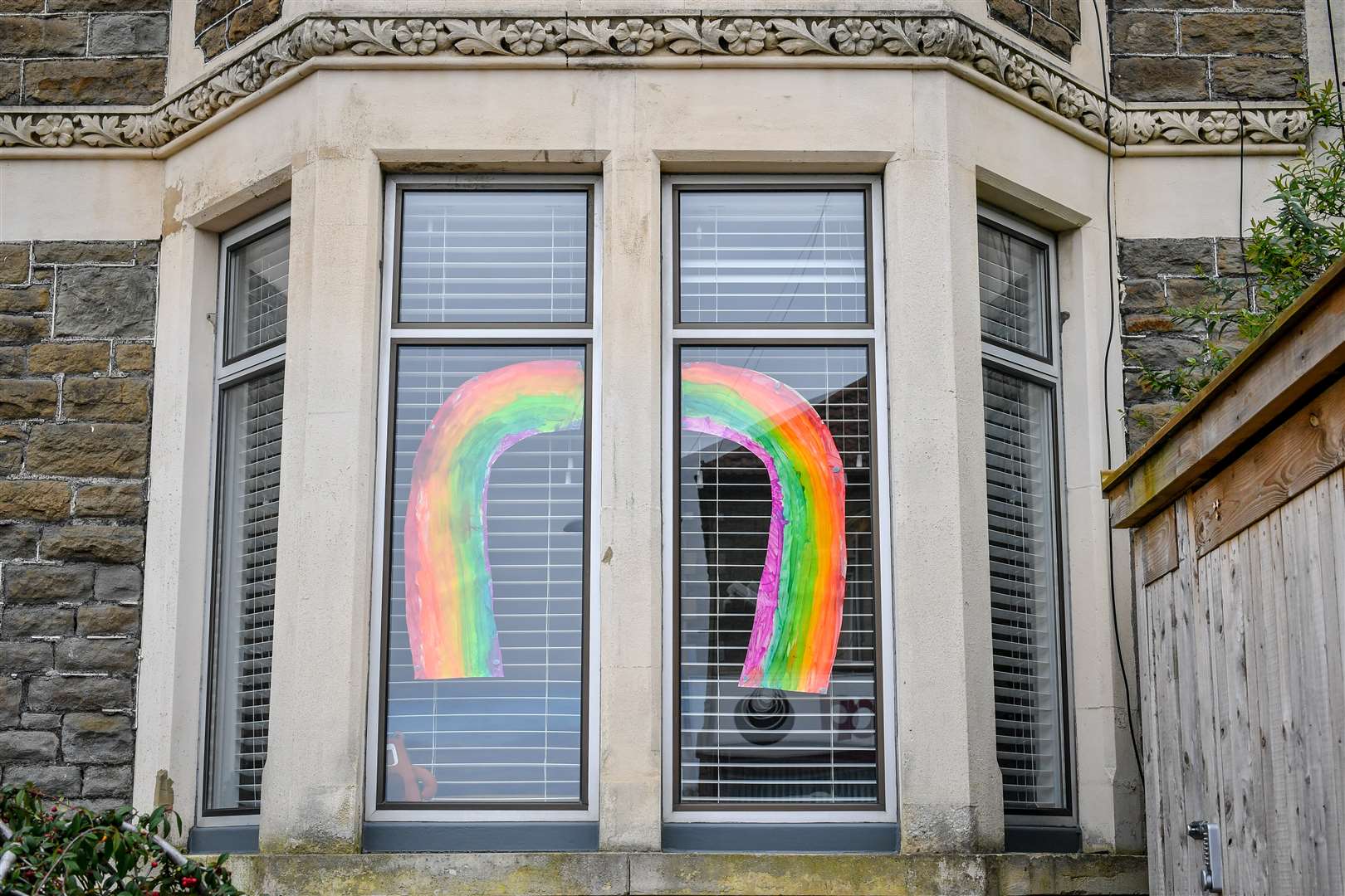 Children across Britain have been keeping themselves busy painting rainbows to display in their windows (Ben Birchall/PA)