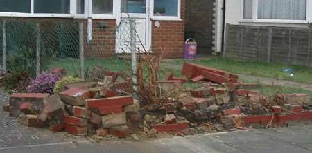 The Royal Mail truck smashed into this front garden after hitting two parked cars. Picture: MIKE PETT