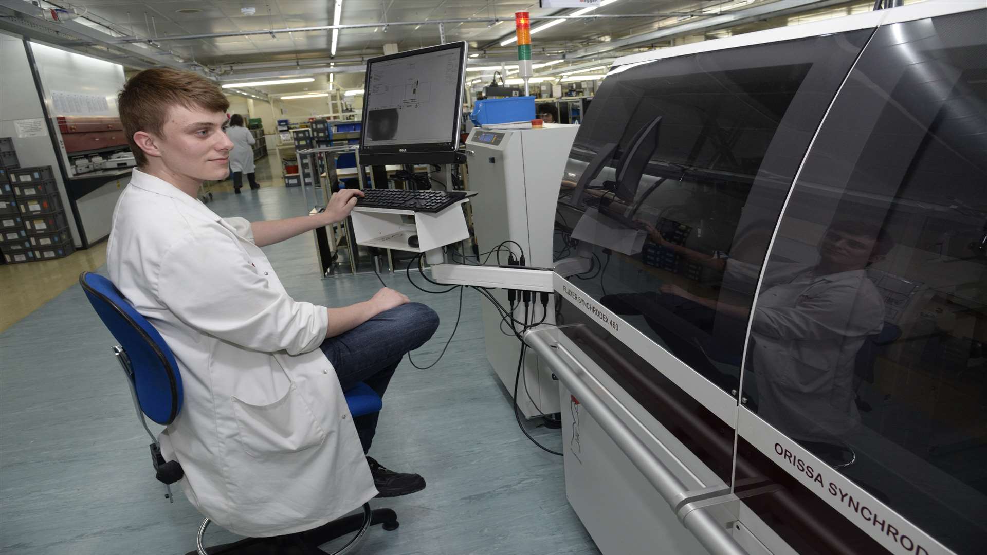 Apprentice Marcus Gray with the selective soldering machine at Megger