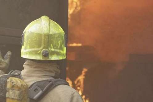 Firefighter tackling a blaze. Stock photo.