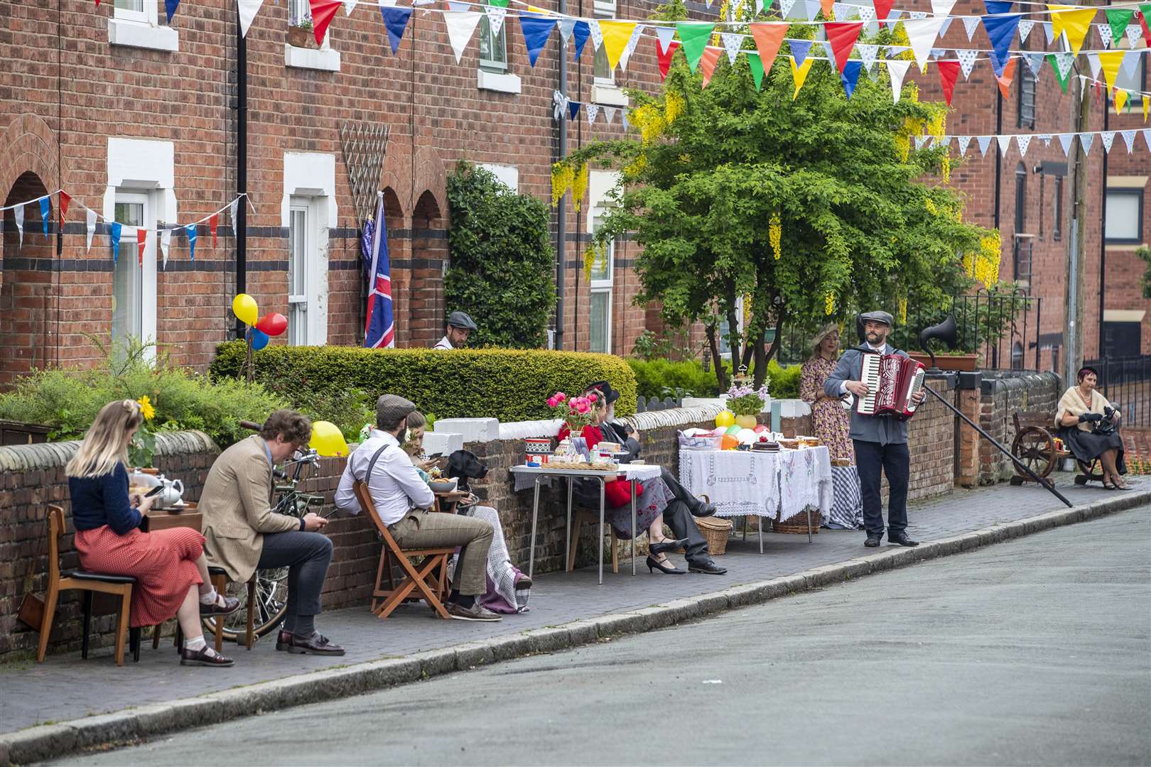 The residents of Cambrian Road in Chester dress up in 1945 clothing and have a social distancing tea party (Peter Byrne/PA)