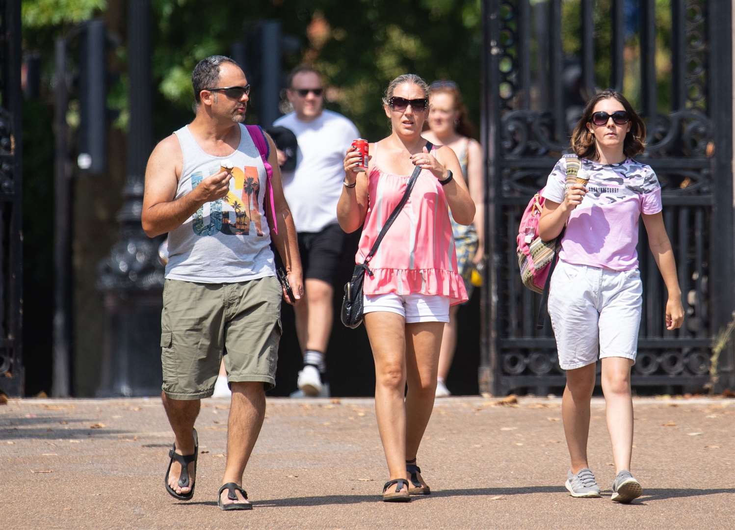 People cool down with an ice cream in St James’s Park (Dominic Lipinski/PA