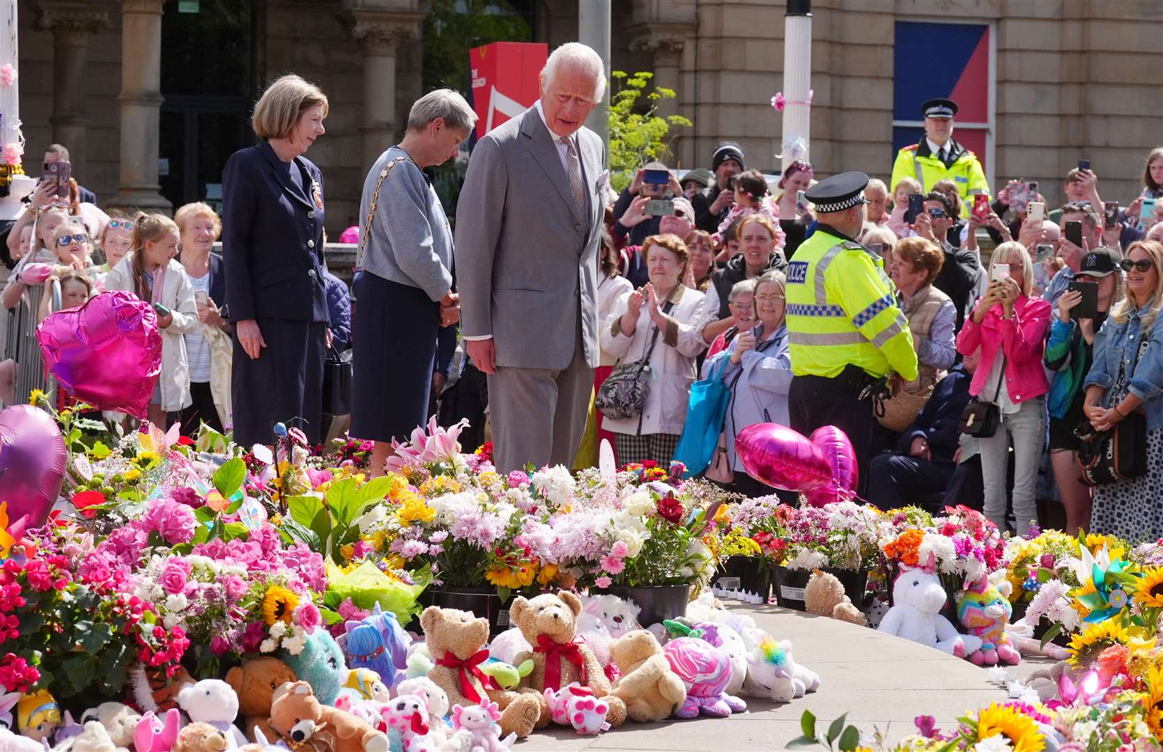 The King views the flowers and tributes outside the Atkinson Art Centre in Southport (Owen Humphreys/PA)