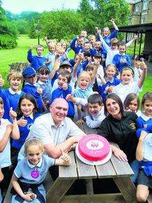 Brian Portanier and Anita Padfield from Minster Walking Bus join children from the scheme to celebrate the 10th anniversary of the schools' buses