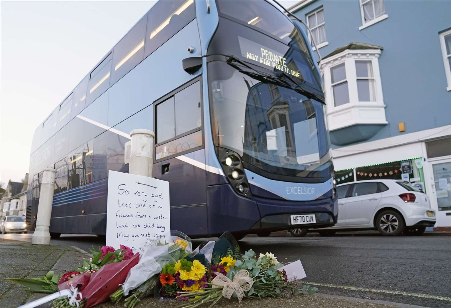 Flowers left at the entrance at Portland Port in Dorset following the death of an asylum seeker on board the Bibby Stockholm in December (Andrew Matthews/PA)