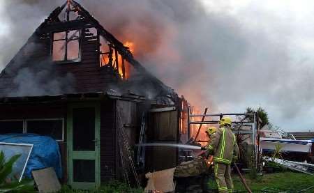 The chalet bungalow goes up in flames. Picture: MARTIN RIVE