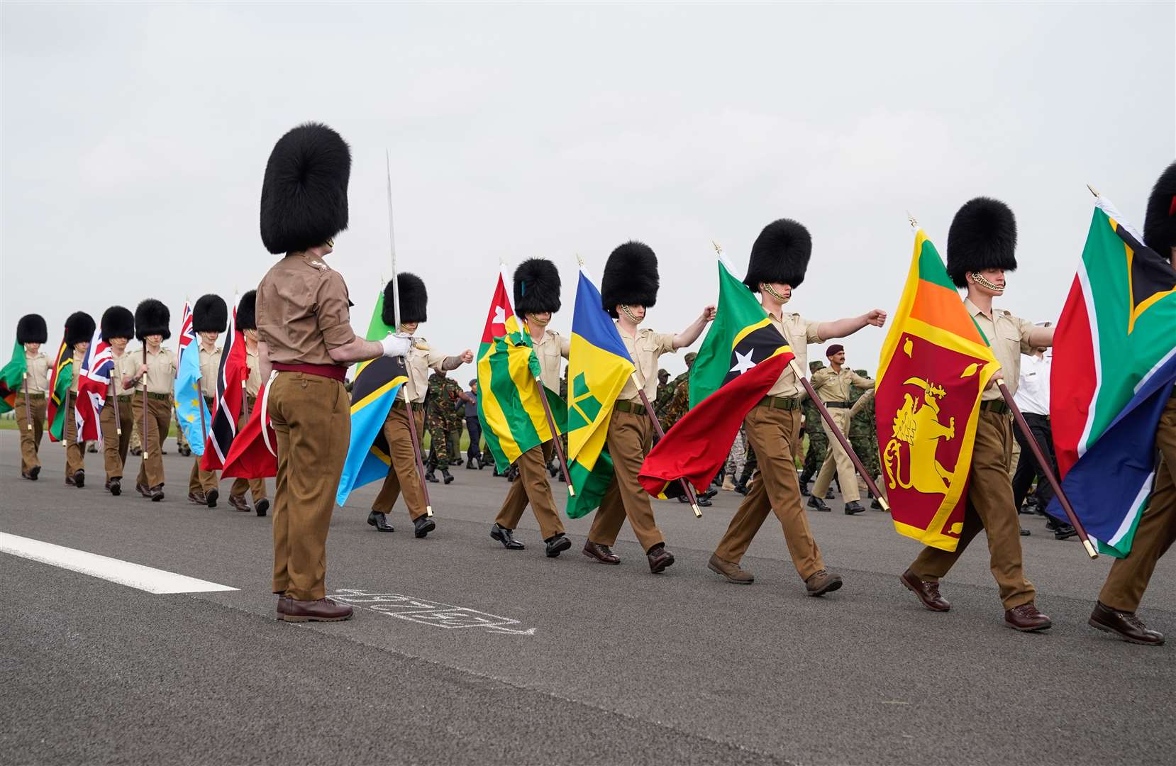 Guards carry flags from Commonwealth countries during the rehearsal at RAF Odiham in Hampshire (Andrew Matthews/PA)