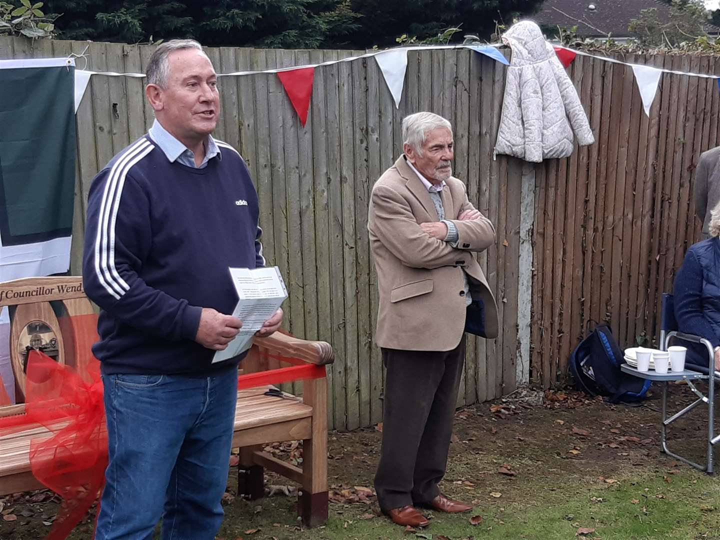 Boxley Parish Council chairman Chris Sheppard addresses residents at the unveiling of a memorial bench, with Bob Hinder alongside