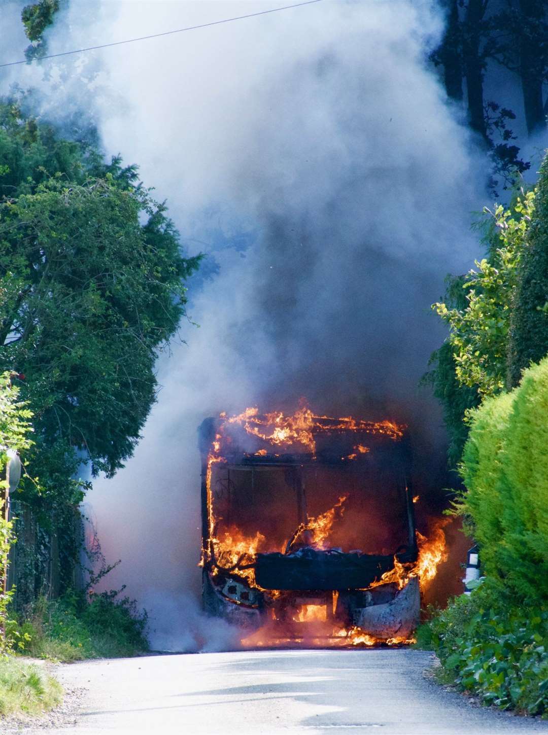 Smoke fills the narrow lane where the bus was forced to stop. Picture: UKNiP