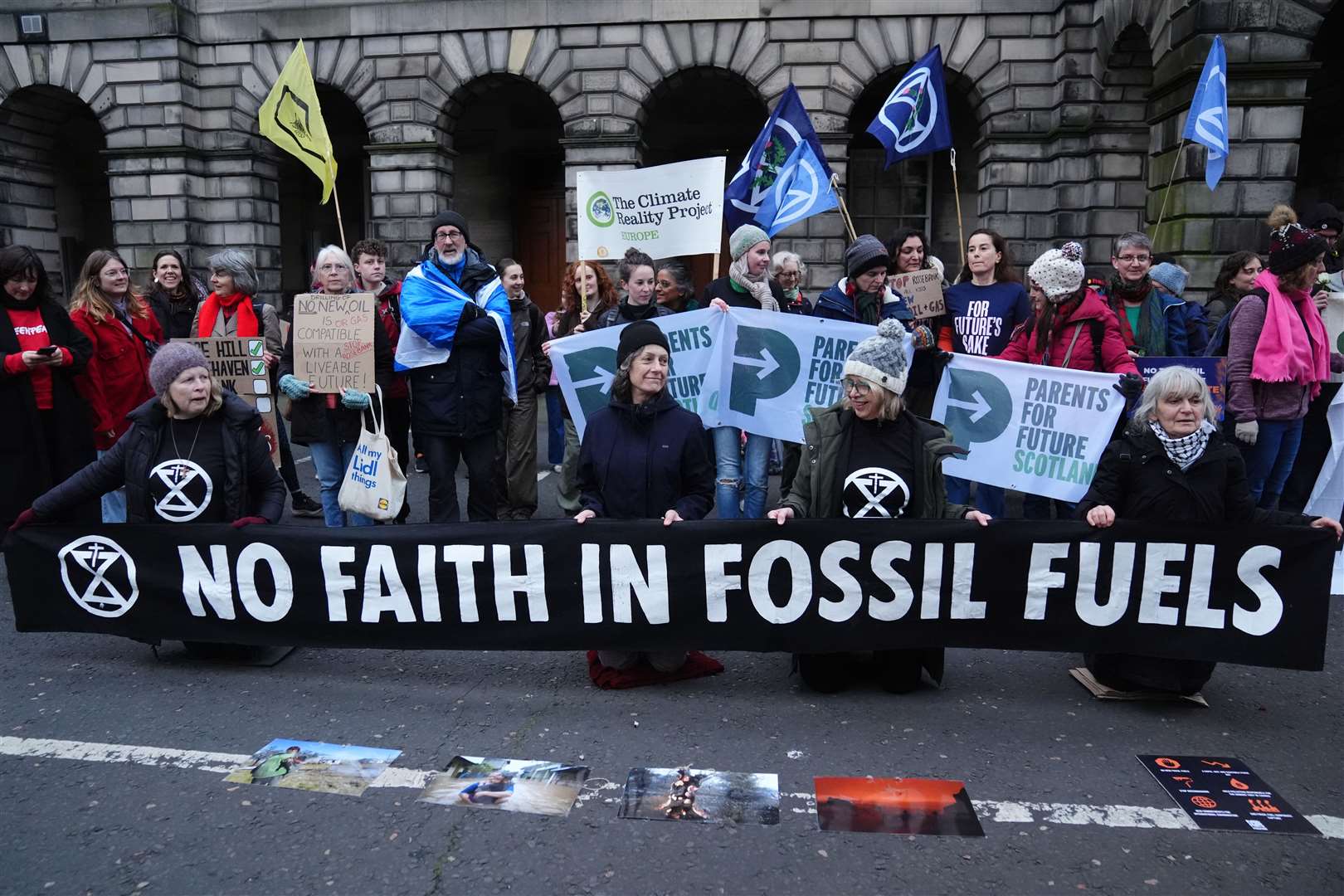 Climate activists from Greenpeace and Uplift during a demonstration outside court ahead of the hearing (Andrew Milligan/PA)