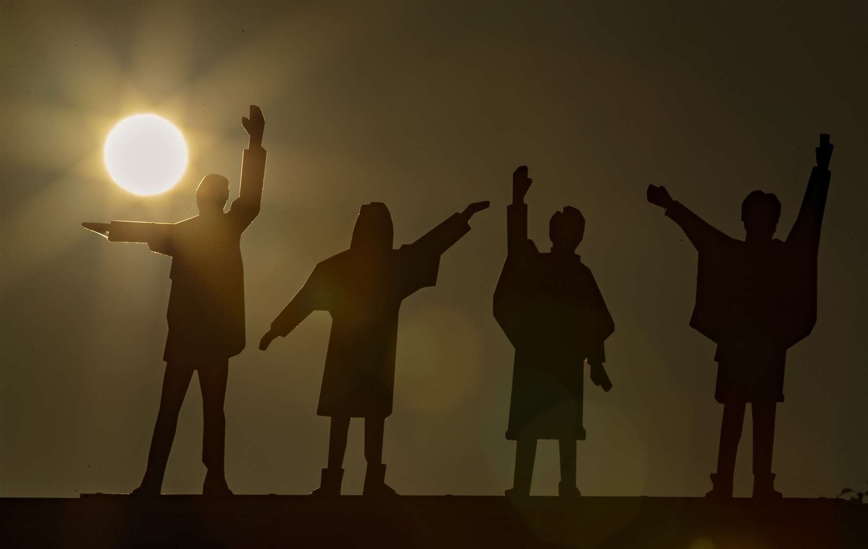 The sun rises above the statues of the Beatles in Penny Lane, Liverpool (Pete Byrne/PA)