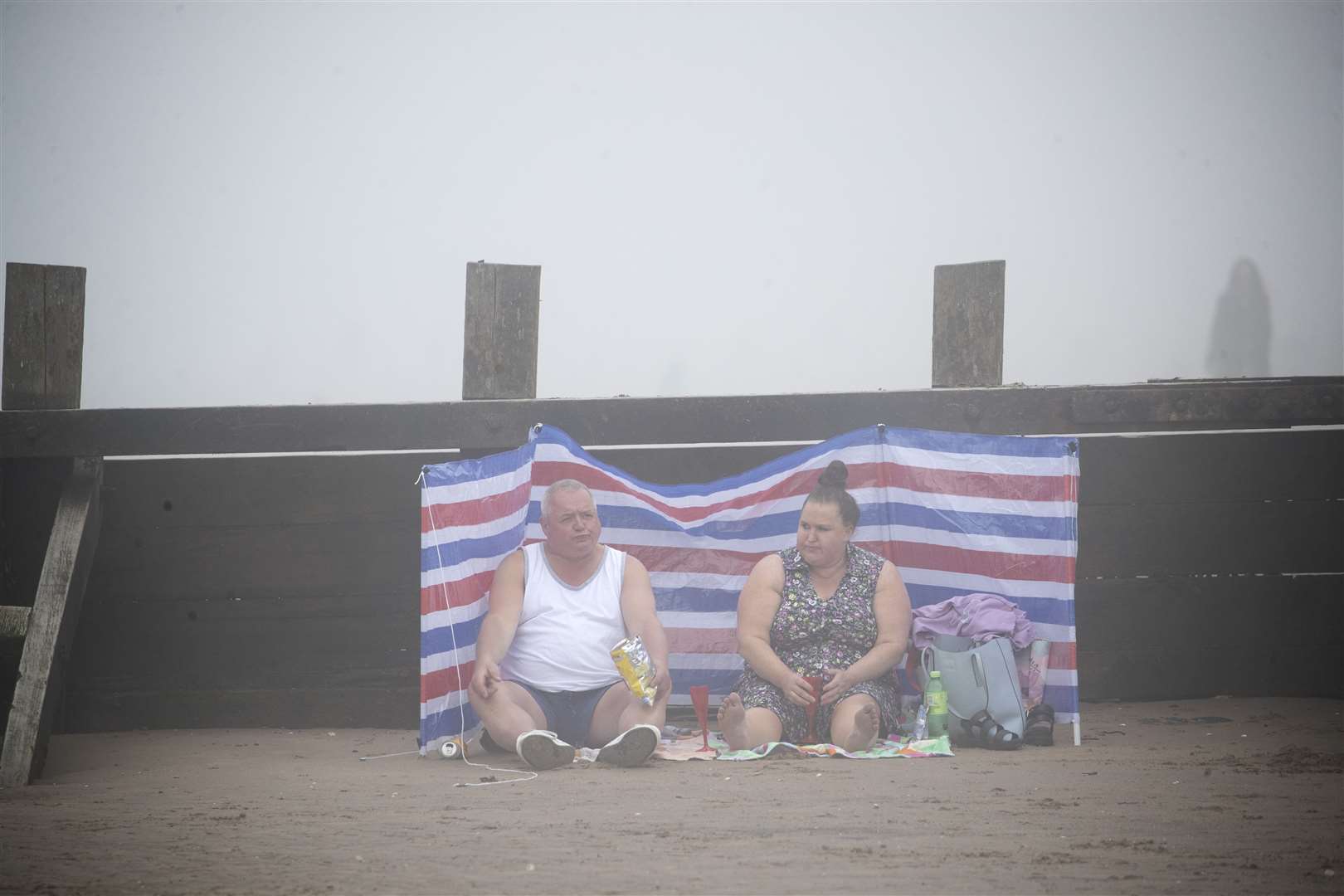 People on Edinburgh’s Portobello Beach surrounded by mist (Jane Barlow/PA)