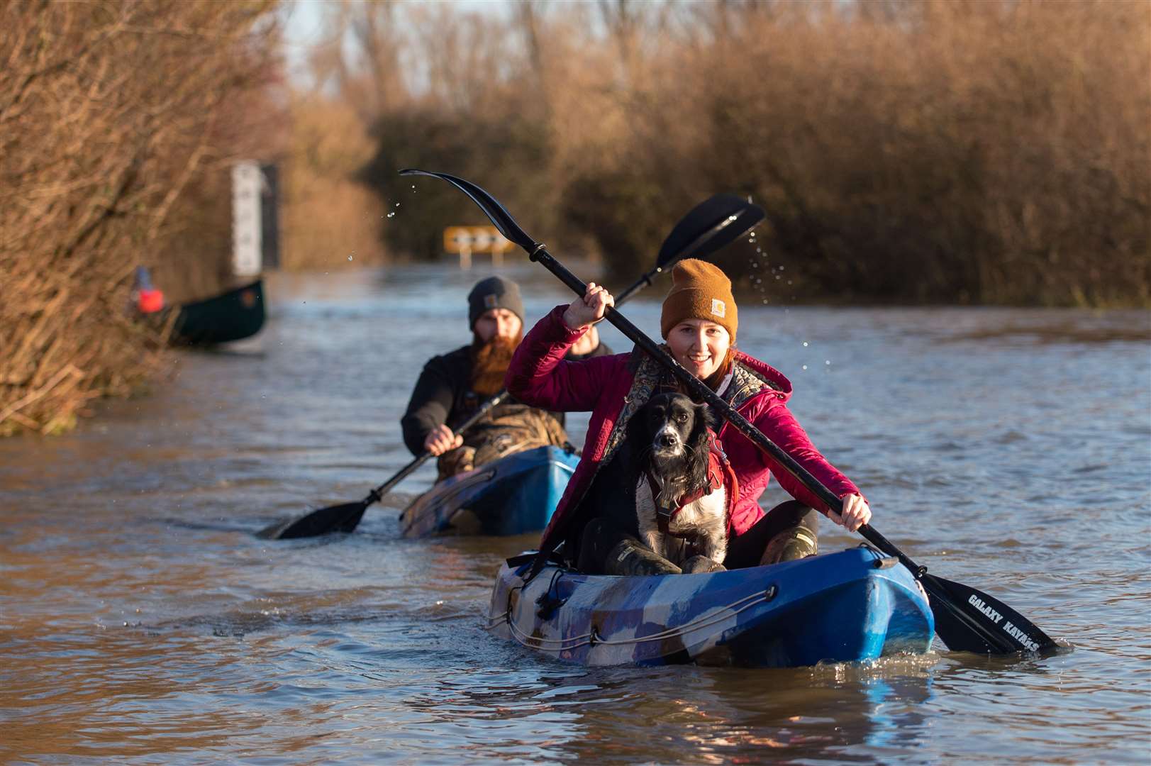 People kayak along the flooded A1101 in Welney, Norfolk (Joe Giddens/PA)