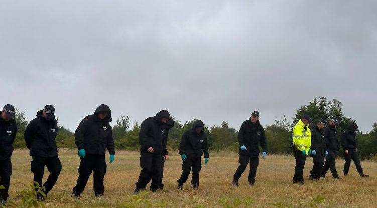 Police officers were seen searching a field near Southfields Way