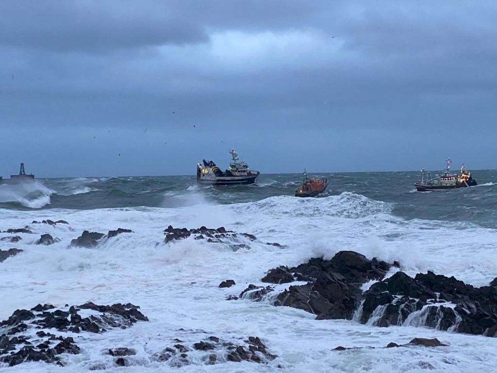 The lifeboat attached a tow to the stricken vessel (left) and towed it to safety (RNLI Peterhead/PA)