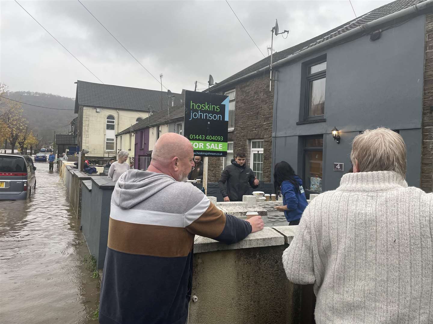 Residents attend to their properties on Sion Street in Pontypridd, Wales, following flooding (George Thompson/PA)