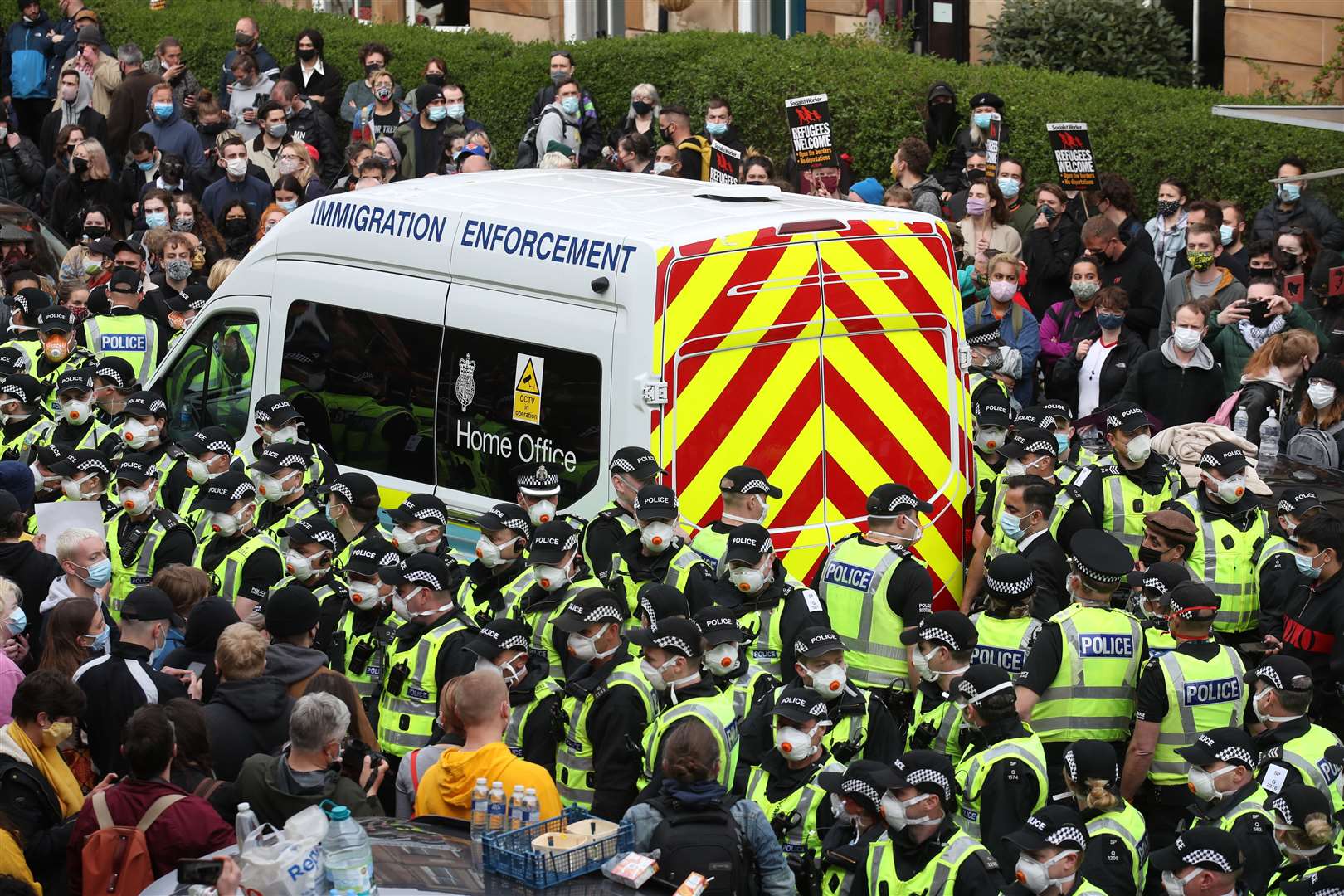 Police surrounded an immigration van in Kenmure Street, Glasgow, amid a large-scale protest (Andrew Milligan/PA)