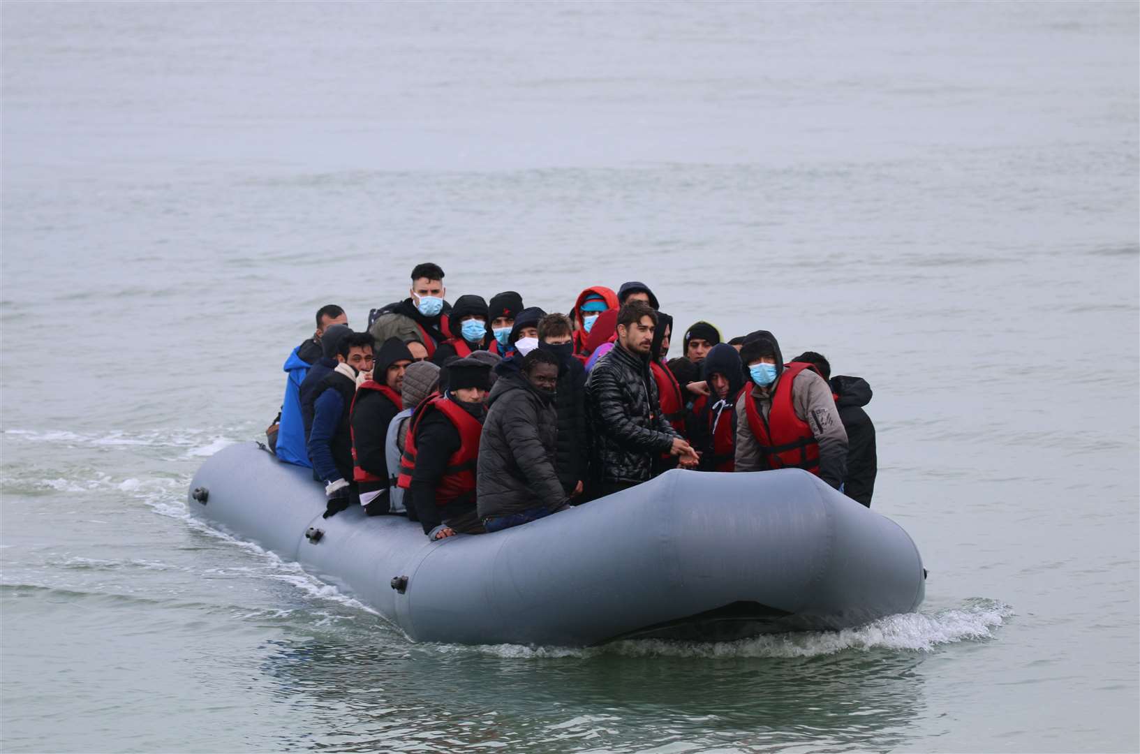 Asylum seekers landing on the beach in Kent.