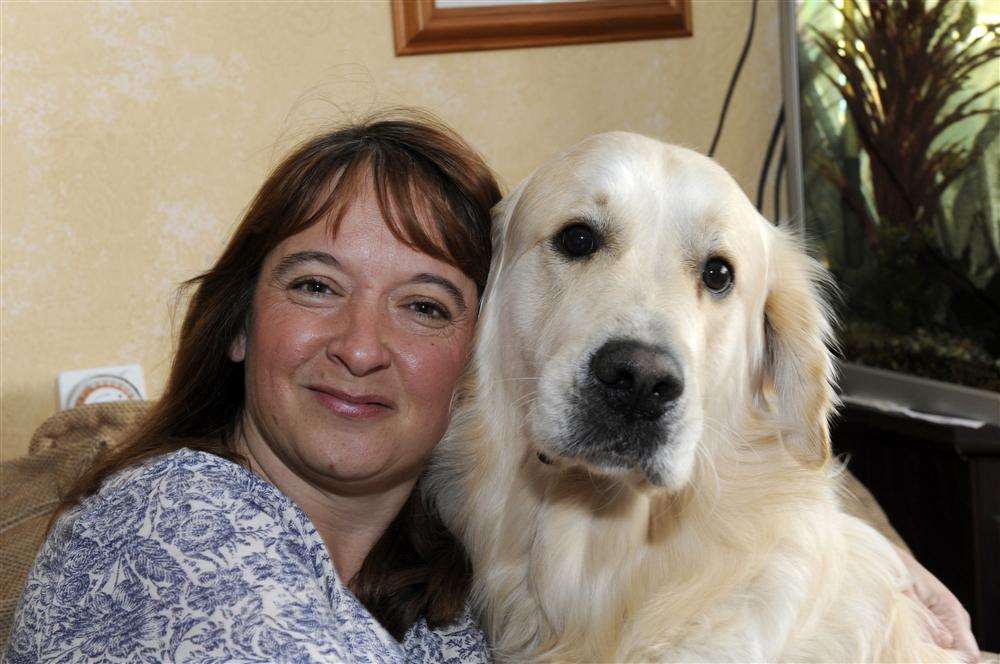 Sharon Cairns, from Ramsgate, prepares to say goodbye to golden retriever Dexter to go husky sledding.