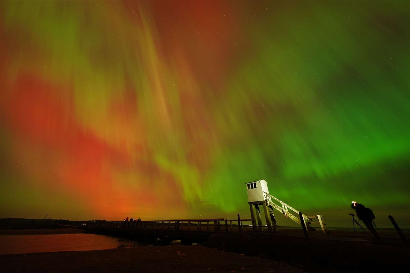 Aurora displays occur when charged particles collide with gases in the Earth’s atmosphere around the magnetic poles (Owen Humphreys/PA)