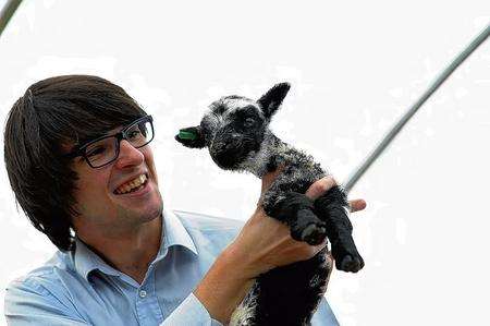 Chris Price meets one of the newborns, Rare Breeds Centre, Woodchurch