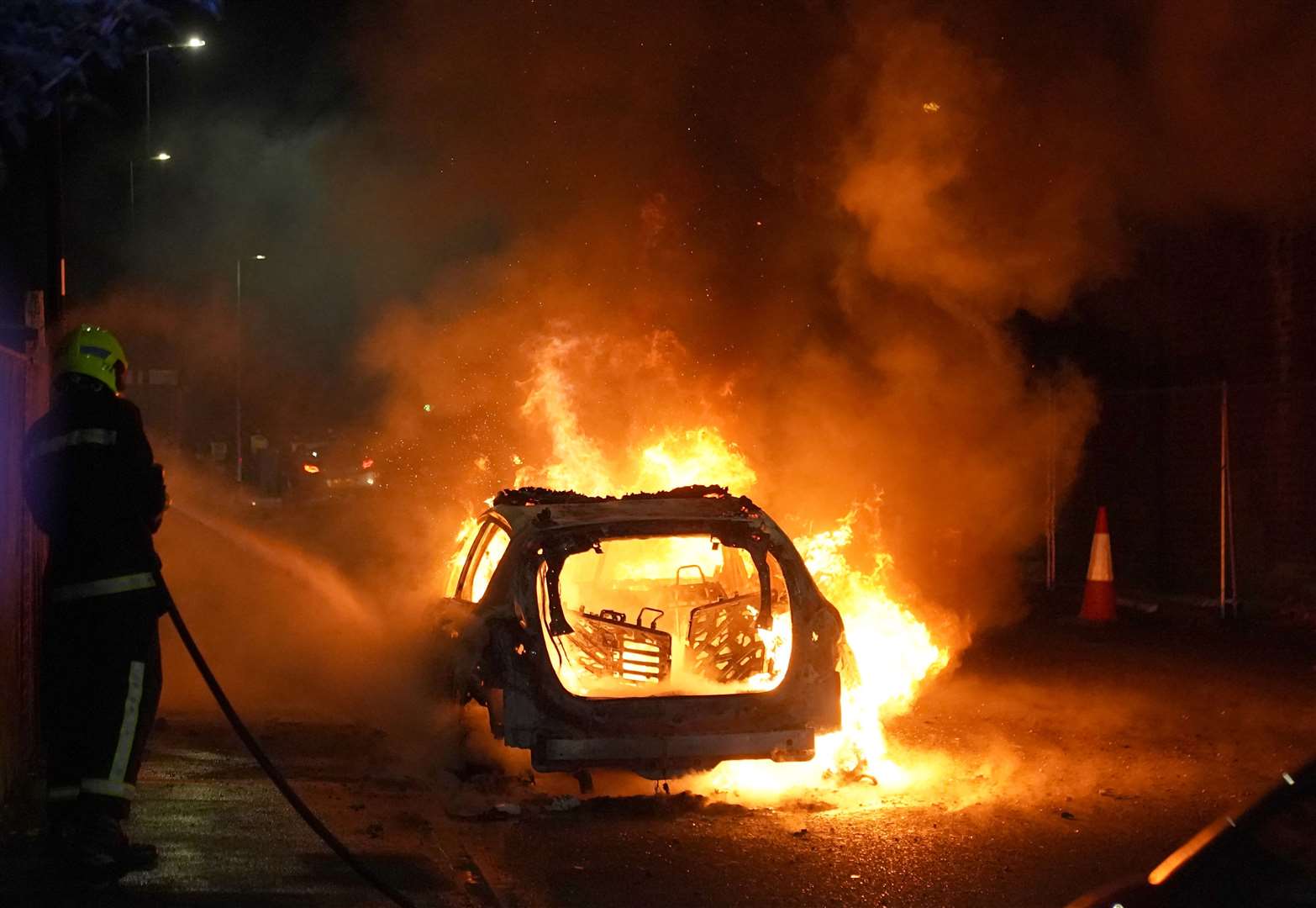 Demonstrators in Hartlepool set fire to a police car during clashes with officers on Wednesday (Owen Humphreys/PA)