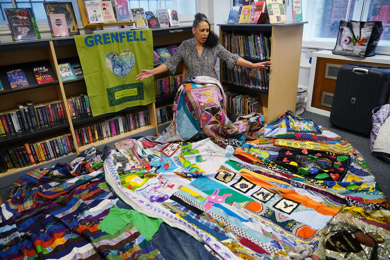 Artist Tuesday Greenidge, founder of the Grenfell Memorial Quilt Project, holding the work in progress (Yui Mok/PA)